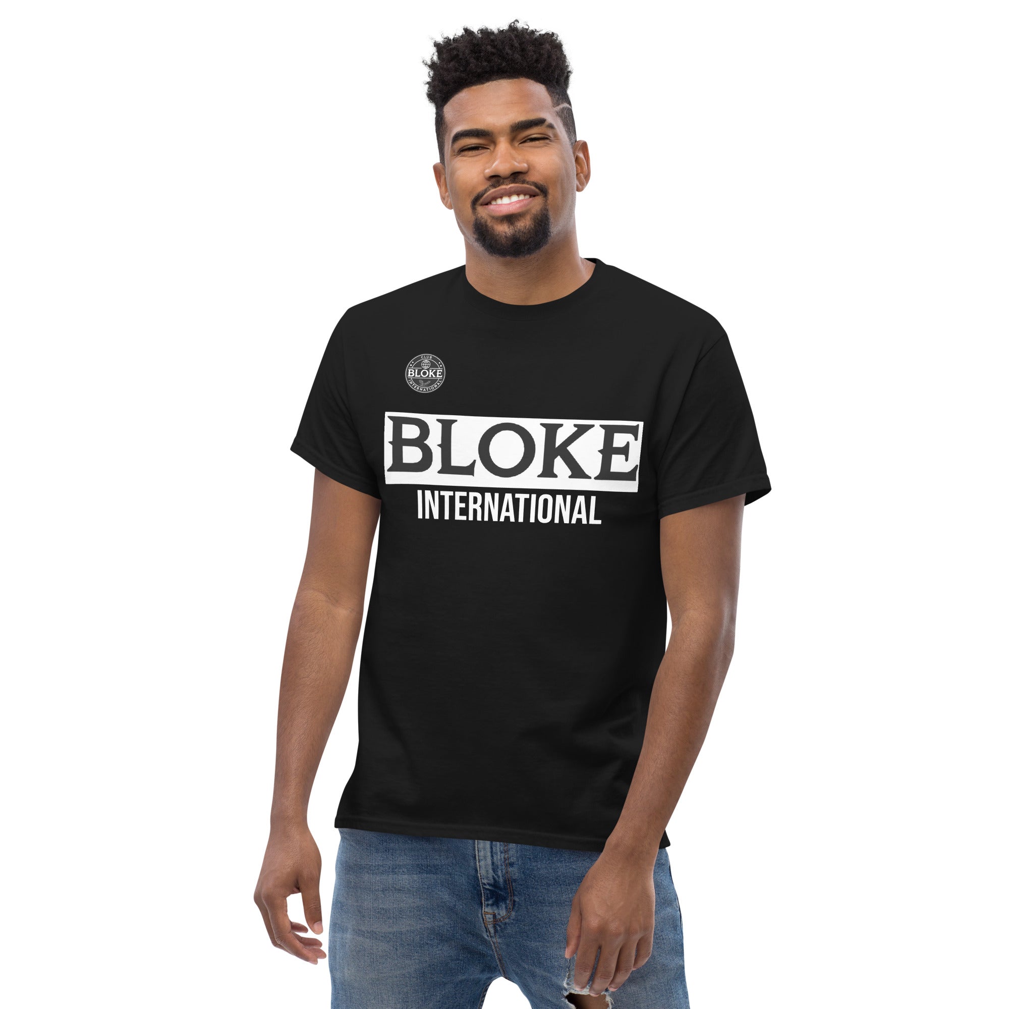Man wearing black "Bloke International" T-shirt, casual pose, minimal background